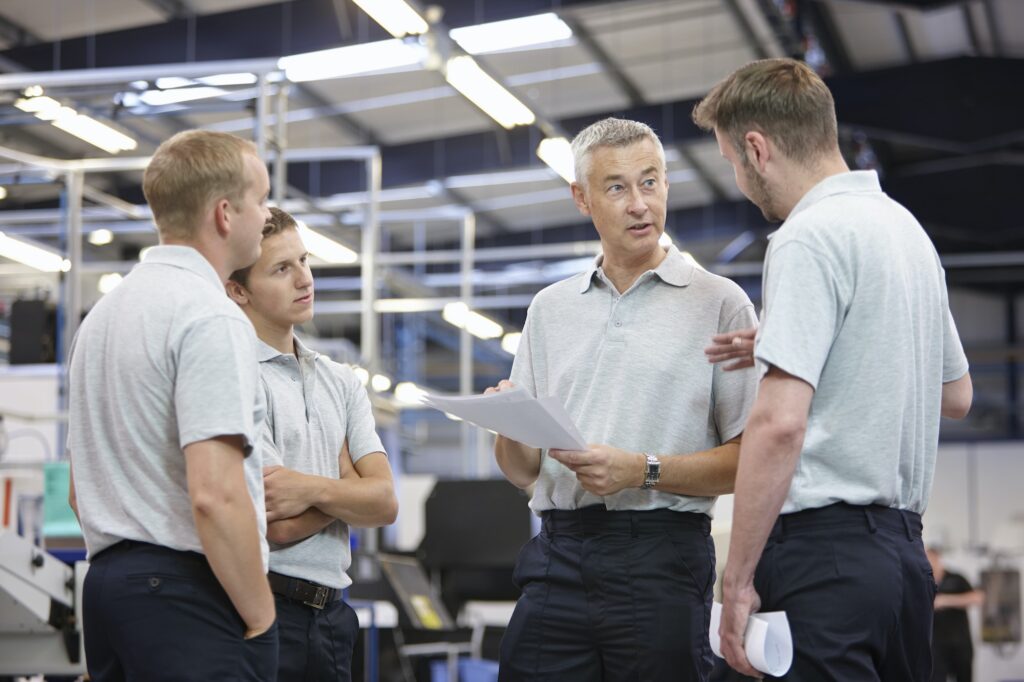 Workers meeting in engineering factory